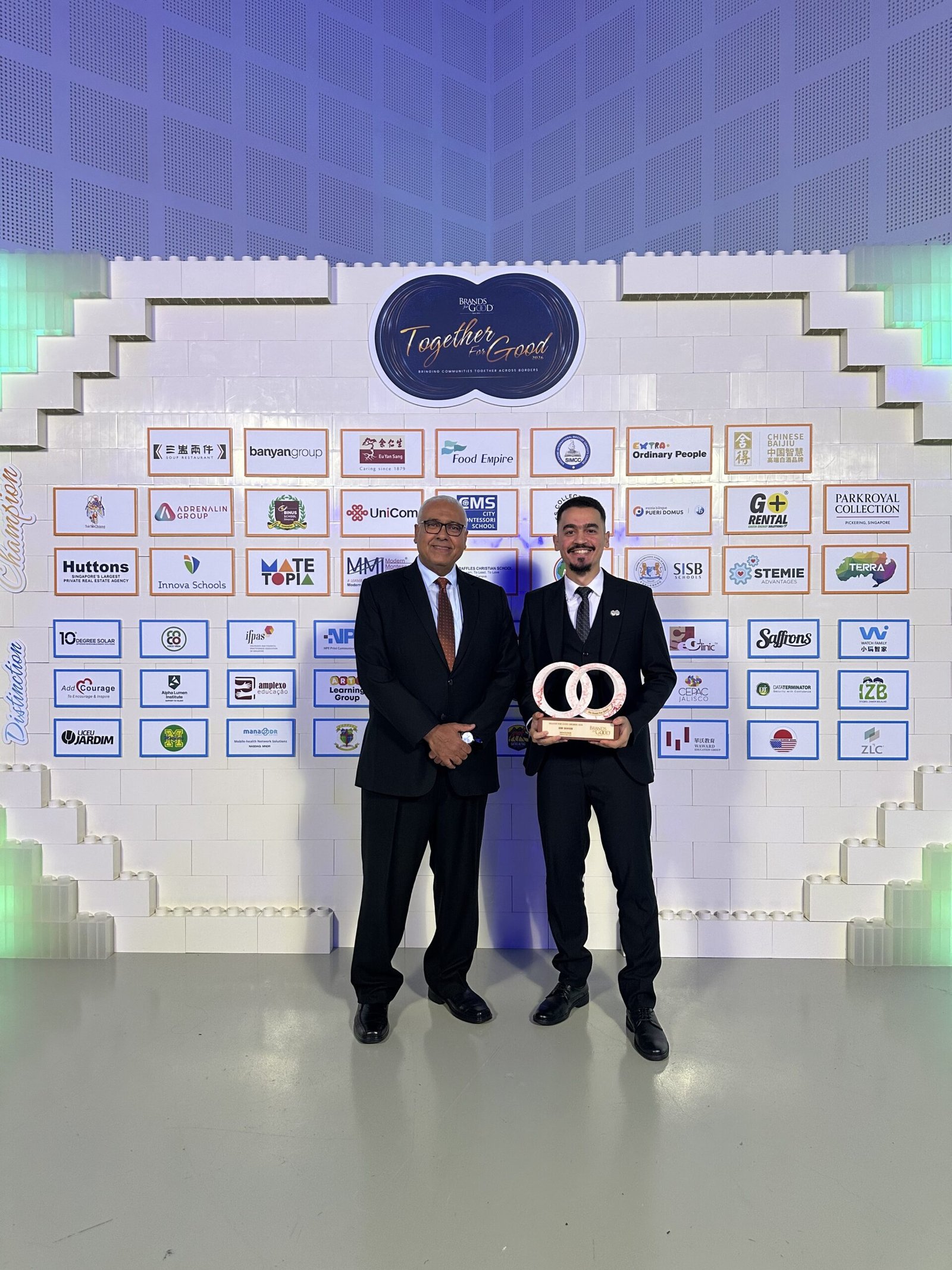 Omar Walid and Ambassador Ahmed Mostafa standing at the gala wall