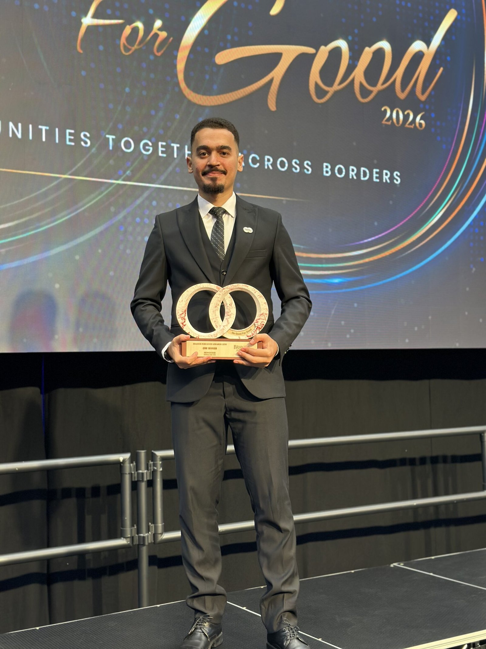 Omar Walid portrait holding trophy on stage